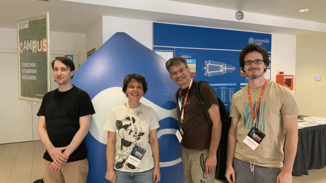 Group photo of the webshapers in front of the Druplicon in the entrance hall of Drupal Dev Days 2023.
